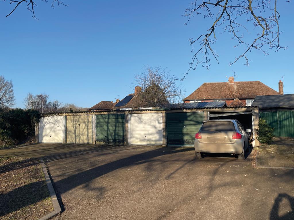 Lot: 86 - SIX GARAGES AND OVER A THIRD OF AN ACRE WITH FURTHER POTENTIAL - View of garages in Hunton village